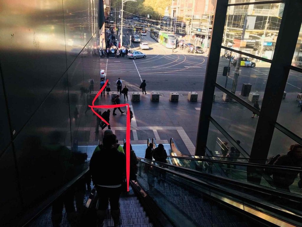 passengers are taking a escalator