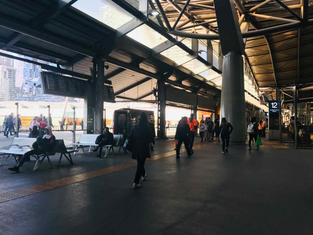 passengers walk inside the train station